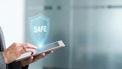 Cyber security high level planning concept with safe shield icon over tablet in modern office background