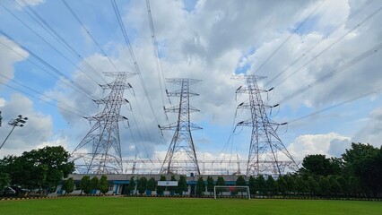 Three high-voltage transmission towers from a substation
