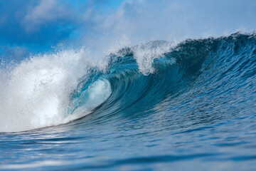 Blue Ocean Wave Curling Toward Shore, Giant Turquoise Barrel Captured MidBreak, Spray Arcing, Sunlight