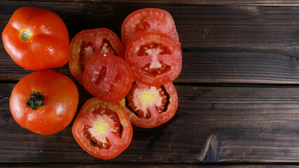 Top view fresh tomatoes on wooden board background, sliced