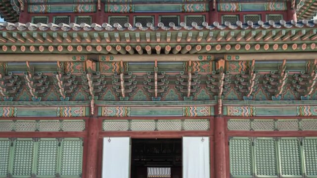 Intricate Korean Traditional Architecture With Elaborate Colorful Roof Details Under A Clear Blue Sky