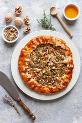 Homemade sweet open pie galette with brie cheese, pears and walnuts