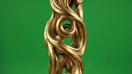 Isolated three-dimensional abstract curve sculpture featuring an antique gold vine motif rotating slowly on a pure green screen background screen, alpha, abstract - Powered by Adobe