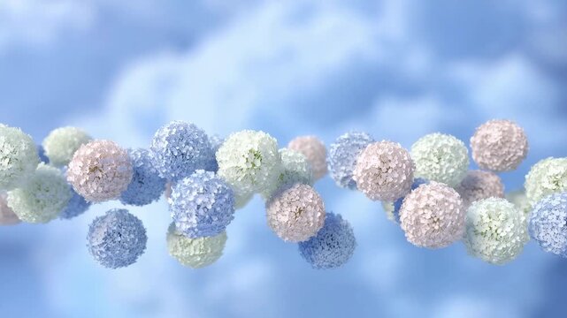 Floating pastel pompoms sway in gentle breeze against blue sky background