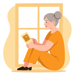 Elderly woman sitting by the window and looking at a photo frame. Elderly set 