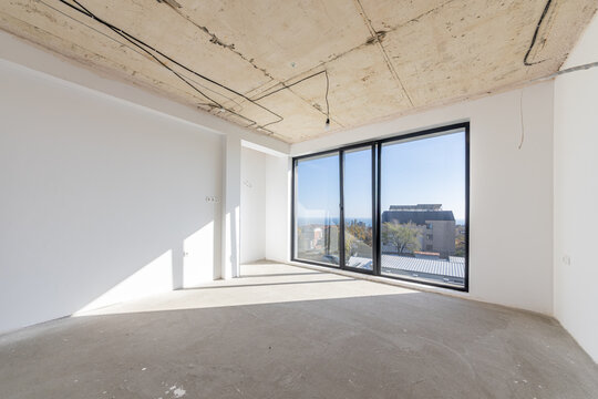 New empty room under construction. New home. Concrete walls. Interior renovation.
