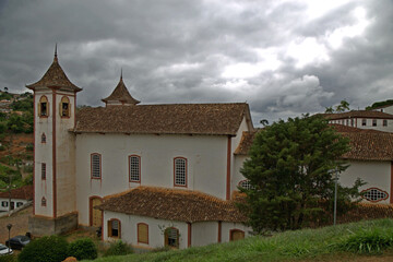 Cloudy sky, dense clouds.
Our Lady of the Conception Church in the small town of Serro in Minas Gerais, Brazil, Portuguese colonial style architecture.