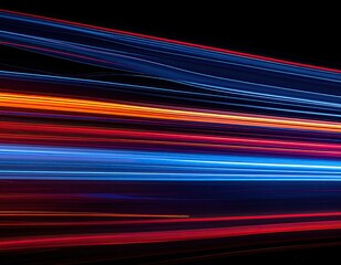 Long exposure shot of light streaks in red, orange, and blue hues against a black background