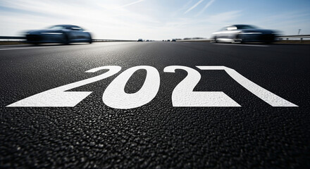 Starting to new year 2027 and need for speed to begin new year for business.word 2027 written on the asphalt road.