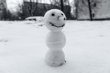 An ugly smiling snowman with no arms or legs