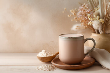Mug of healthy bone supplement drink with white collagen powder on a light wooden table, minimalist aesthetic background copy space banner