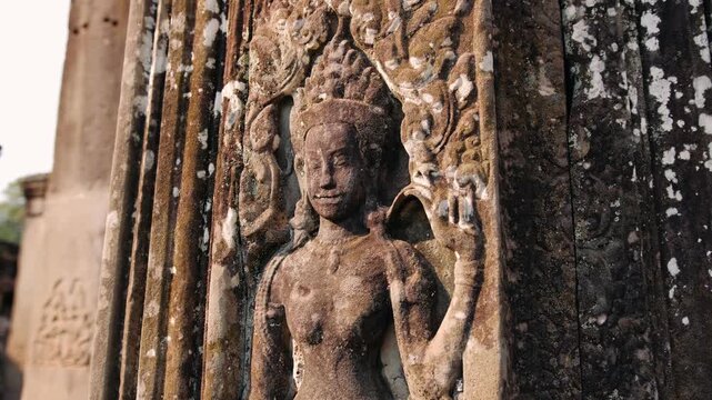 Apsara bas relief skillfully carved into a stone pillar at the historic bayon temple in angkor, Cambodia. Archeology concept.