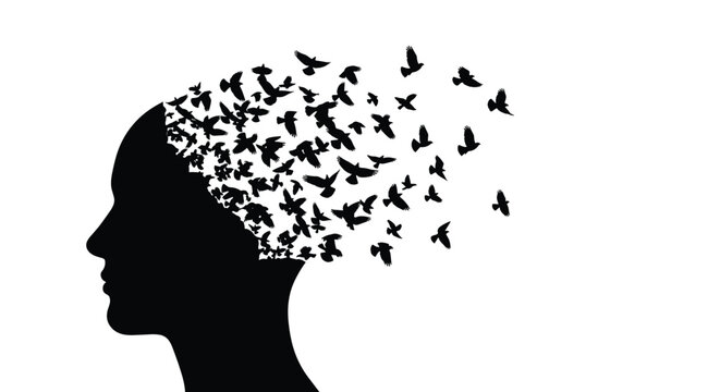 Conceptual silhouette of a human head with a flock of birds flying out from the mind representing freedom and creative imagination.