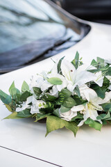 Elegant limousine for hire for weddings with a flower wreath on