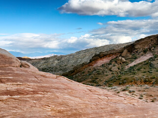 Valley of fire park landscape in Nevada state of America during nice winter day showing snow in background on mountains