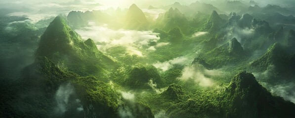 Lush green mountain peaks with mist and sunlight creating a serene and mystical atmosphere