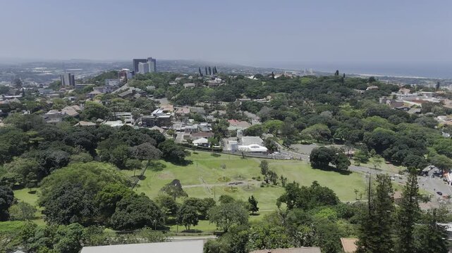 Drone orbits left from the south the northwest side of Jameson Park on sunny day in Windermere neighborhood in Durban, South Africa