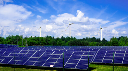 solar panels and wind turbines generating electricity in power station green energy renewable with...