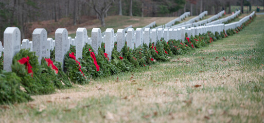 Panoramic view of wreaths left at veterans graves at a National Cemetery for Wreaths Across America day. Placed by volunteers.  Copy space available  © Andrew