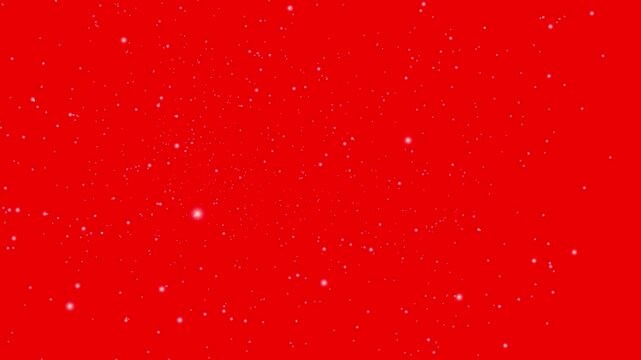 Gentle white snowflakes drift against a vibrant red background, creating a festive and magical winter atmosphere.