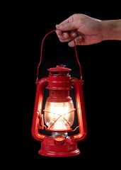 Hand holding an antique red lantern in the dark: Symbol of hope © showcake