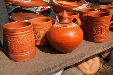 Rustic Terracotta Pottery Collection on a Wooden Shelf