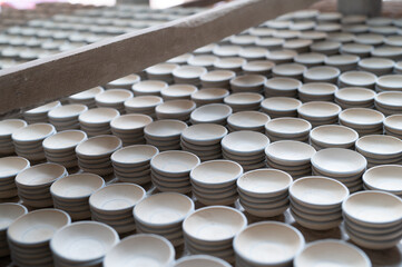Ceramic craftsmanship: White clay cups stacked neatly in the factory