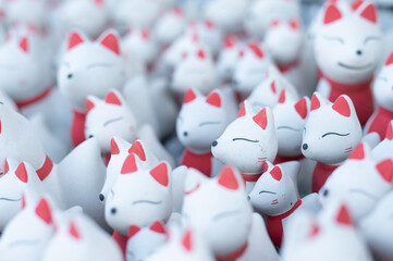 Ceramic Kitsune fox dolls lined up: Symbol of a Japanese shrine