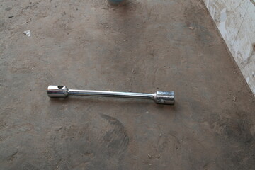Chrome Lug Wrench on Concrete Floor