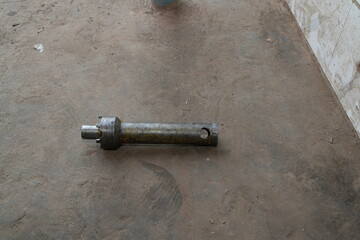 Worn Industrial Metal Pin on Concrete Floor