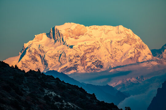 Golden alpenglow on Nadi Chuli (7,871 meters), also known as Peak 29, photographed from the Tilicho Valley near Shree Kharka along the Annapurna Circuit in Nepal. This massive Himalayan peak rises 