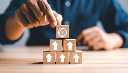 Business strategy concept with wooden blocks showing upward arrows and a target, symbolizing growth, success, and goal achievement in professional environment
