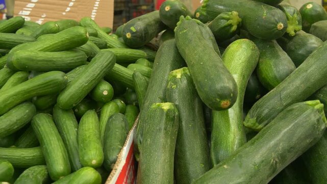 Fresh Zucchini and Cucumbers Displayed at Farmers Market Representing Healthy Local Organic Vegetables
