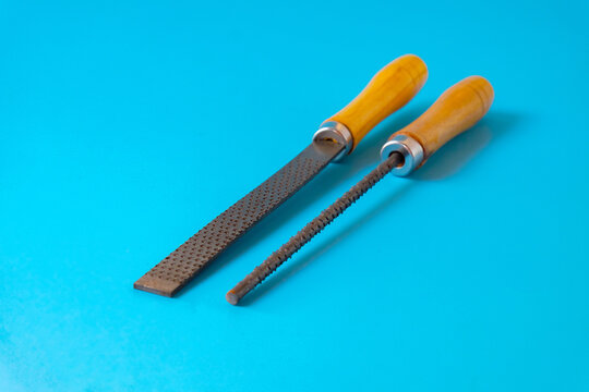 wood file tool for a carpenter craftsman who smoothes a piece of wood with a rasp.