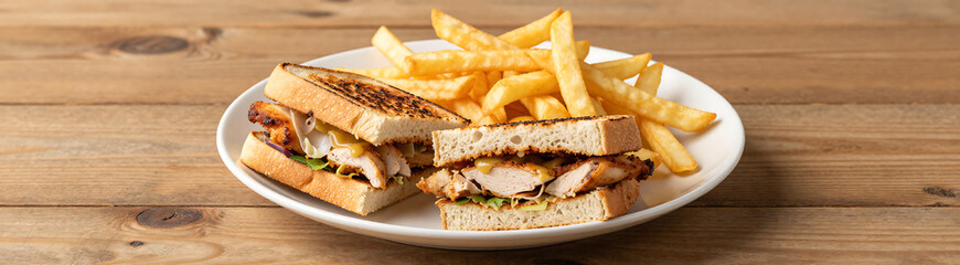 warm natural light illuminates rustic wooden table large white plate sits center showcasing two perfectly toasted chicken