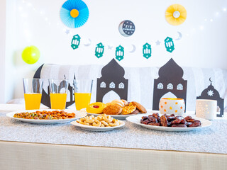 Eid Mubarak table with Ramadan sweets, dates, nuts and festive decor