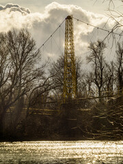 Aerial view of the sky and a suspension bridge over the river