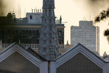 Neogothic spire rising above city rooftops