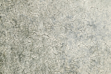 Obraz premium Close-up of deteriorated plaster surface with cracked paint layer. Distressed wall texture suitable for backgrounds, overlays, and creative design use.