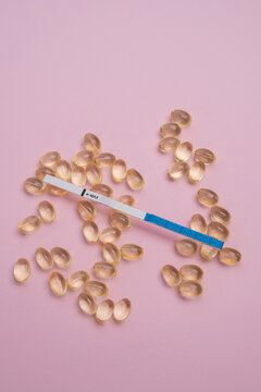 Fertility planning and pregnancy testing concept with calendar and supplements
