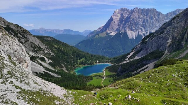 Aerial drone view of the Alps mountains, with Coburger H&uuml;tte located near the scenic lakes Seebensee and Drachensee on a bright, sunny summer day. People are enjoying a beautiful view.