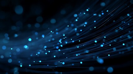 Artistic depiction of light trails and bokeh effects against a deep blue and black backdrop