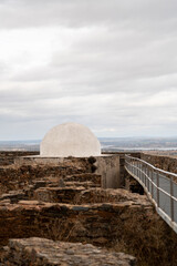 Fototapeta premium Historic stone structure with white dome and modern walkway