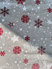 Christmas fabric pattern featuring red snowflakes and stars