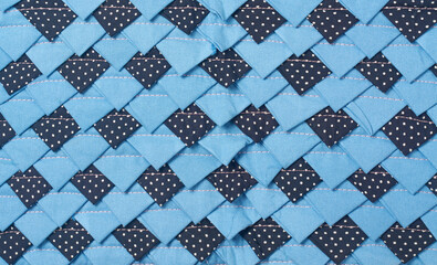 patchwork fabric mat textile surface, overlapping light and dark blue woven material texture, closeup full frame view, textile craft background concept