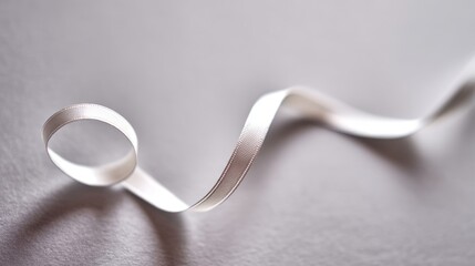 drape. A white ribbon curving downward against a minimalist gray background. wellbeing guides, coaching materials, designed for mental health education and mindfulness programs, clarifies learning.
