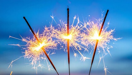 Three Bright Sparklers Illuminating a Festive Celebration Against a Soft Blue Background.