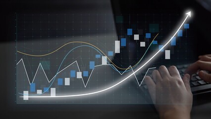 A close-up of hands typing on a laptop keyboard with a stock market graph on the screen, showcasing data trends and upward growth indicators vital for investment strategies. Copula