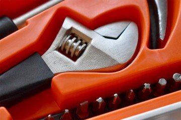 Close-up of an adjustable wrench inside a toolbox, representing home repair, mechanical work and maintenance tools.