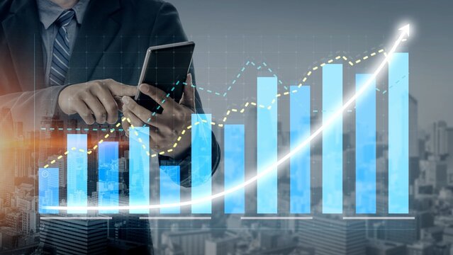A businessman in a suit interacts with a smartphone while financial graphs and charts illustrate growth and analysis against a modern city backdrop. Copula - Powered by Adobe